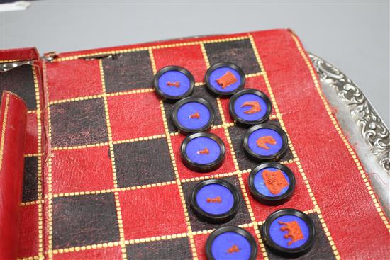 A 19th century Jaques Patent portable B.C.D. backgammon, chess and draughts board set, the gilt tooled red morocco cylinder holder